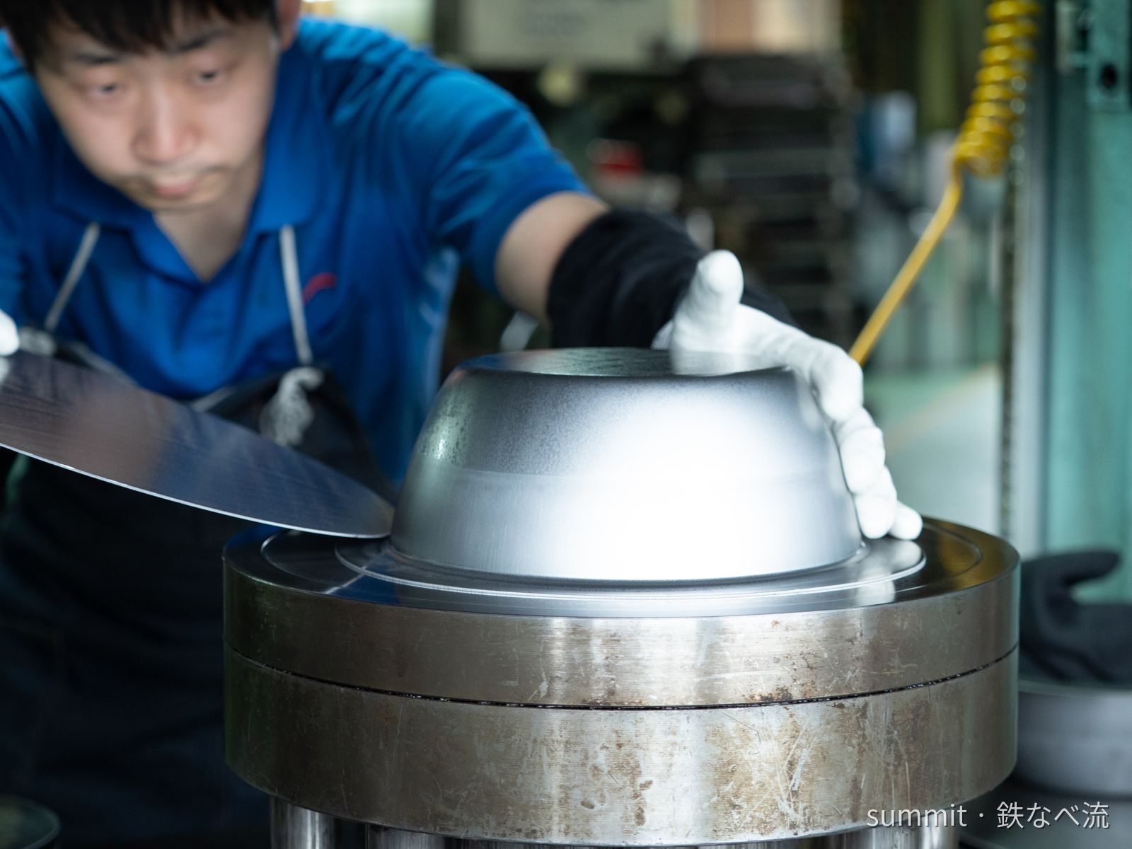 A Summit craftsman checking a freshly formed pan